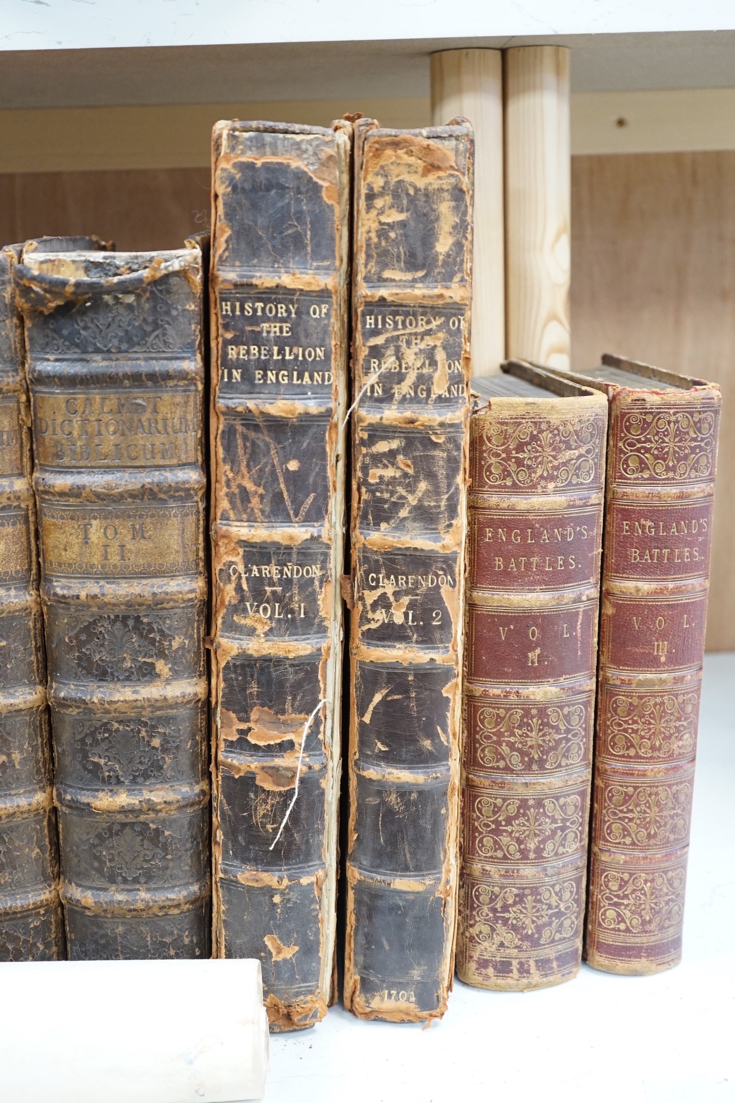 A quantity of leather and cloth bound books and a poster